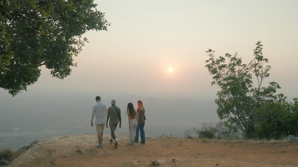 Group of people standing on a hill during sunset in Tanzania